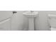 Simple powder room with a pedestal sink and white walls at 1114 Centerview Drive, Nashville, NC 27856
