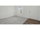 Neutral living room with light gray carpet, wood flooring and a front door at 1114 Centerview Drive, Nashville, NC 27856