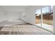 Sunlit living room featuring hardwood floors, a sliding glass door to the backyard, and neutral decor at 1114 Centerview Drive, Nashville, NC 27856