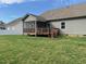 Back exterior view of house with screened porch and deck overlooking the spacious backyard and green lawn at 115 Pecan Harvest Dr, Garner, NC 27529