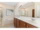 Well-lit bathroom features double sinks, large mirror, tub, and separate shower at 115 Pecan Harvest Dr, Garner, NC 27529