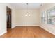 Elegant dining area featuring hardwood floors, natural light, and an adjacent opening to the kitchen at 115 Pecan Harvest Dr, Garner, NC 27529