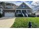 Charming two-story brick home with a well-manicured lawn and attached two car garage at 115 Pecan Harvest Dr, Garner, NC 27529