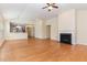 Bright living room with hardwood floors, fireplace, ceiling fan, and open access to the kitchen at 115 Pecan Harvest Dr, Garner, NC 27529