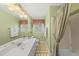 Bright bathroom with a double sink vanity and tiled shower at 11801 Strickland Rd, Raleigh, NC 27613