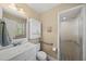 Clean bathroom featuring a white vanity, ample lighting, and a walk-in shower with glass doors at 11801 Strickland Rd, Raleigh, NC 27613