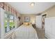 Charming bedroom with a cozy bed, bedside table, and bright window at 11801 Strickland Rd, Raleigh, NC 27613