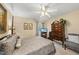 Relaxing bedroom with comfortable furnishings, a classic wood dresser, and a view of the outdoors at 11801 Strickland Rd, Raleigh, NC 27613