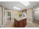Spacious kitchen with island, tile flooring and stainless appliances. Includes a doorway to an adjacent room at 11801 Strickland Rd, Raleigh, NC 27613
