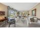 Bright living room with white sofas, zebra print chairs, and large windows with decorative valances at 11801 Strickland Rd, Raleigh, NC 27613
