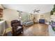 Comfortable living room with hardwood floors, a ceiling fan, and large windows at 11801 Strickland Rd, Raleigh, NC 27613