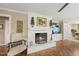 Cozy living room with a painted brick fireplace, complemented by comfortable seating and bright natural light at 11801 Strickland Rd, Raleigh, NC 27613