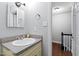 Bathroom featuring a granite countertop vanity, framed mirror, and modern fixtures at 1248 Jamestown Ct, Cary, NC 27511