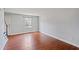 Bright bedroom featuring hardwood floors and a window with natural light at 1248 Jamestown Ct, Cary, NC 27511