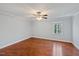 The bedroom offers hard wood floors, a window and a light gray paint at 1248 Jamestown Ct, Cary, NC 27511