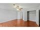Spacious bedroom featuring hardwood floors, ceiling fan, and a walk-in closet at 1248 Jamestown Ct, Cary, NC 27511