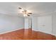 Spacious bedroom featuring hardwood floors, ceiling fan, and double closets at 1248 Jamestown Ct, Cary, NC 27511