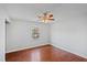 This bedroom features gray walls, hardwood floors and a ceiling fan with an attached light fixture at 1248 Jamestown Ct, Cary, NC 27511