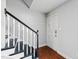 Traditional entryway with stairs, black railing, and sleek hardwood floors at 1248 Jamestown Ct, Cary, NC 27511