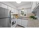 Well-lit kitchen with stainless steel appliances and granite countertops at 1248 Jamestown Ct, Cary, NC 27511