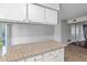 Modern kitchen island with granite countertops and access to other rooms at 1248 Jamestown Ct, Cary, NC 27511