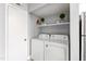 Convenient laundry room with shelving for storage and modern appliances at 1248 Jamestown Ct, Cary, NC 27511