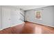 Cozy living room with hardwood floors, a window, and staircase access at 1248 Jamestown Ct, Cary, NC 27511