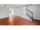 Spacious living room with hardwood floors and staircase access at 1248 Jamestown Ct, Cary, NC 27511