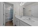 Well-lit bathroom featuring dual vanity sinks and a shower/tub combo at 1408 Weavers Trace Dr, Zebulon, NC 27597