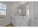 Bright bathroom featuring double sinks and large vanity mirror at 1408 Weavers Trace Dr, Zebulon, NC 27597