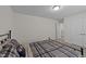 The bedroom offers neutral paint and carpet, as well as a double bed with a plaid coverlet at 1408 Weavers Trace Dr, Zebulon, NC 27597
