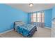 Well-lit bedroom featuring a window and carpeted floors at 1408 Weavers Trace Dr, Zebulon, NC 27597