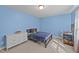 Comfortable bedroom with a bed, dresser, desk and blue walls at 1408 Weavers Trace Dr, Zebulon, NC 27597
