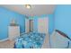 Bright bedroom with blue walls, carpeted floors, and ample storage at 1408 Weavers Trace Dr, Zebulon, NC 27597