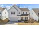 Charming two-story home with an inviting covered front porch and well-manicured landscaping at 1408 Weavers Trace Dr, Zebulon, NC 27597