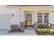 Close-up of the front entrance boasting a welcoming porch, stylish stone accents, and seating area at 1408 Weavers Trace Dr, Zebulon, NC 27597