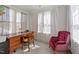 Bright home office with wood desk, plush chair, and natural light at 1408 Weavers Trace Dr, Zebulon, NC 27597