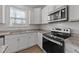 Close-up of a kitchen featuring stainless steel appliances, granite countertops, and modern finishes at 1408 Weavers Trace Dr, Zebulon, NC 27597