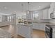 Open concept kitchen with island, granite countertops and views of living and dining area at 1408 Weavers Trace Dr, Zebulon, NC 27597