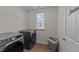 This laundry room features modern, stainless-steel washer and dryer sets and a utility sink at 1408 Weavers Trace Dr, Zebulon, NC 27597