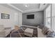 Comfortable living room showcasing tray ceilings, a TV, modern furniture, and neutral decor at 1408 Weavers Trace Dr, Zebulon, NC 27597