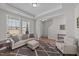 Inviting living room with tray ceilings, natural light, neutral colors, and cozy seating arrangements at 1408 Weavers Trace Dr, Zebulon, NC 27597