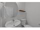 Stylish powder room featuring a round mirror, unique wood shelf, and classic fixtures at 1408 Weavers Trace Dr, Zebulon, NC 27597