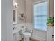 Stylish bathroom with tile floors, window, modern fixtures and plenty of storage at 147 Glenpark Pl, Cary, NC 27511