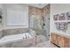 Modern bathroom featuring a tiled shower, soaking tub, and wood cabinets at 147 Glenpark Pl, Cary, NC 27511