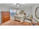 Cozy bedroom with a bed, area rug, side table, accent chair, dresser, and window with blinds at 147 Glenpark Pl, Cary, NC 27511