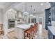 Bright kitchen featuring a large island with bar seating and pendant lighting at 147 Glenpark Pl, Cary, NC 27511
