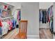 Spacious walk-in closet with custom shelving for optimal organization and a chair for convenience at 147 Glenpark Pl, Cary, NC 27511