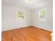 A bedroom featuring natural light, hardwood floors, and neutral-toned walls at 164 Torain St, Hillsborough, NC 27278