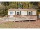 Charming home featuring a wheelchair ramp and wood facade and brick skirting at 164 Torain St, Hillsborough, NC 27278